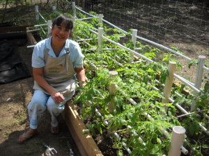 Ramona with Tomatoes in Garden